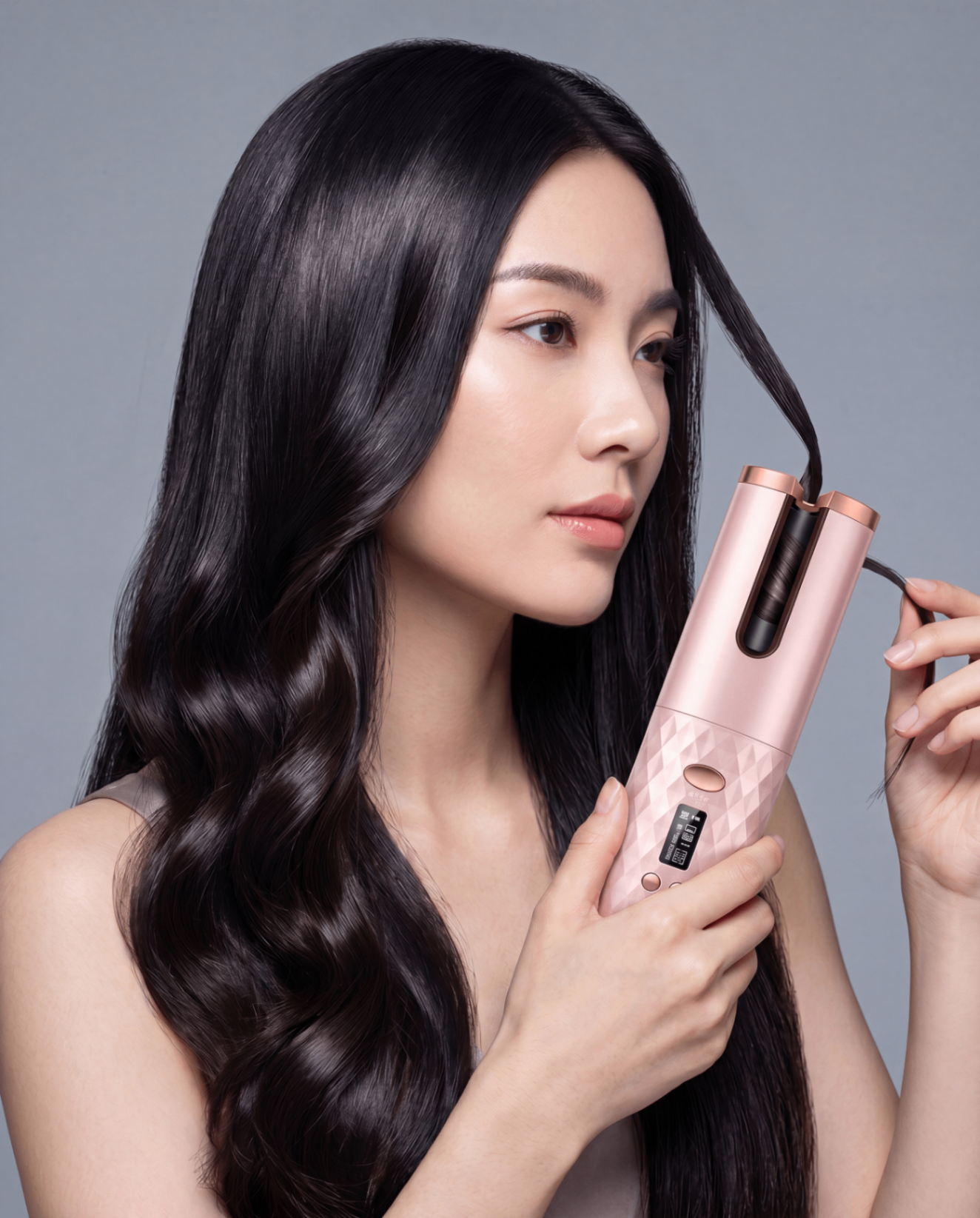 Woman demonstrating the LuxeAir curler while styling dark hair
